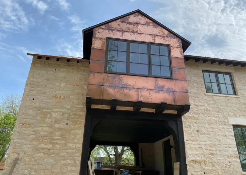 Copper metal panel facade on a stone building for Skylight Installation in South Daytona